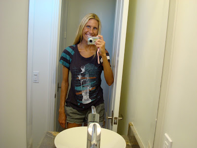 Woman showing off shirt in mirror