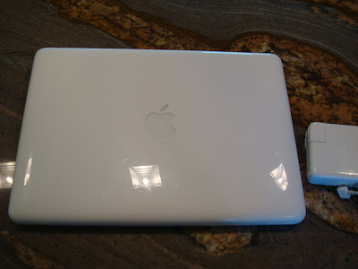 Closed MacBook with charger next to it
