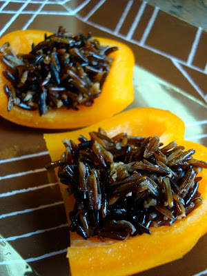 Cooked Wile Rice in sliced orange peppers