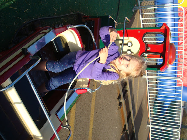 Young girl riding mini train