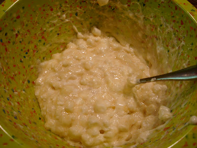 Spoon stirring melted marshmallows and butter in bowl