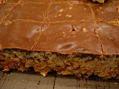 Row of finished GF Vegan "Rice Krispie" Treats with Chocolate Peanut Butter Coconut Oil Frosting