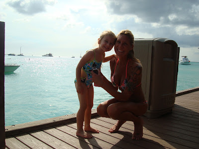 Young girl and woman in bathing suits on dock