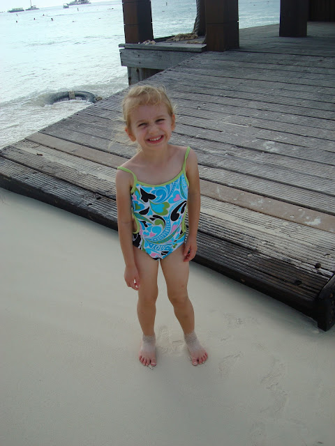 Young girl in bathing suit next to pier