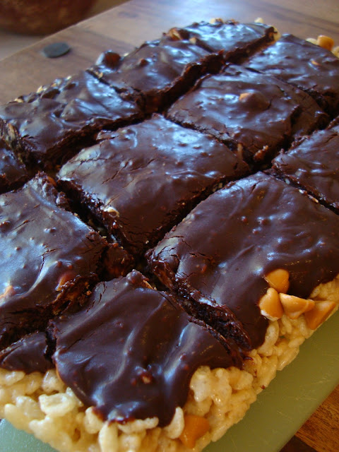  Rice Krispie Treats on cutting board topped with Vegan Chocolate Frosting cut into bars