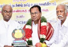 Rev.Fr.S.John Britto, left, conferring the title ‘Tamil Mamani’ award to P. Valanarasu