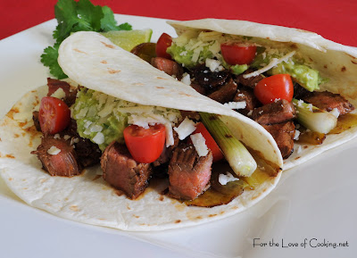 steak, anaheim chile, and scallion tacos with guacamole and cotija cheese