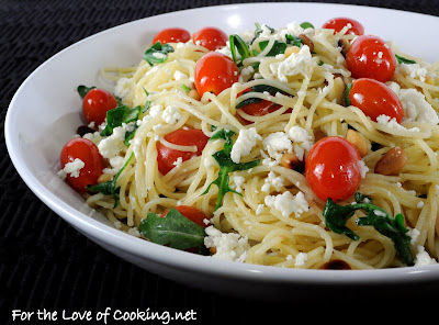 Angel hair pasta with arugula, feta cheese, tomatoes, and pine nuts