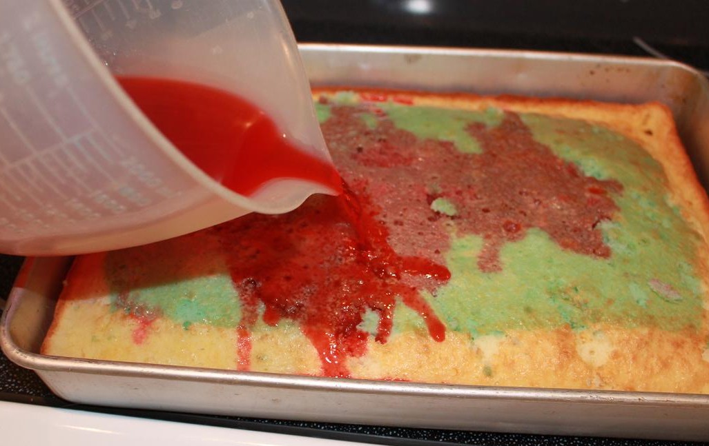 this is jello and alcohol pouring onto a jello cake