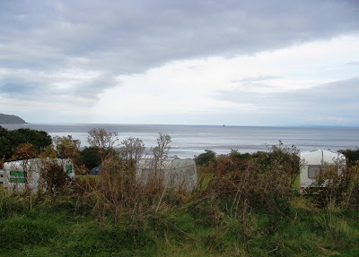 View past caravans out to sea with a cloudy sky