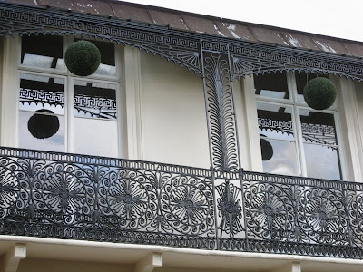 Regency balcony with wrought iron and hanging foliage balls