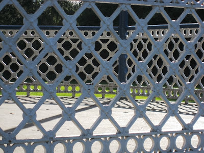 Lattice patterns formed by the metalwork of the side of the bandstand