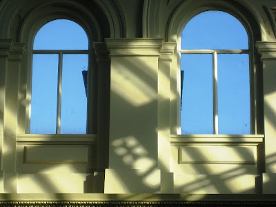 Blue sky through two arched windows