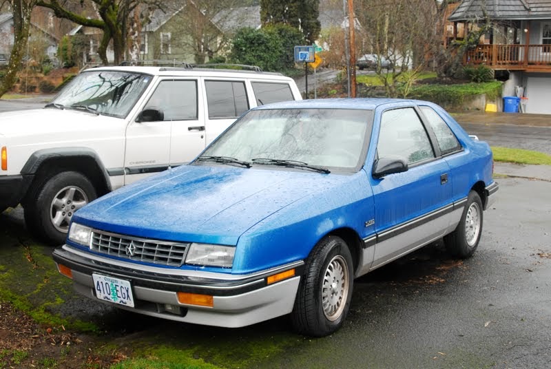 OLD PARKED CARS. 1989 Plymouth Sundance RS Turbo Coupe.