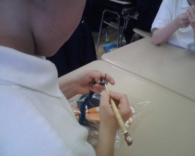 Dee Jr. crocheting with his new hook at school