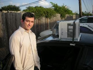 a home window A/C unit on top of the car