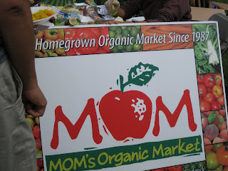 Moms Organic Market table sign