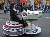Sister Ruth (click to enlarge her glitzy mobile piano)
