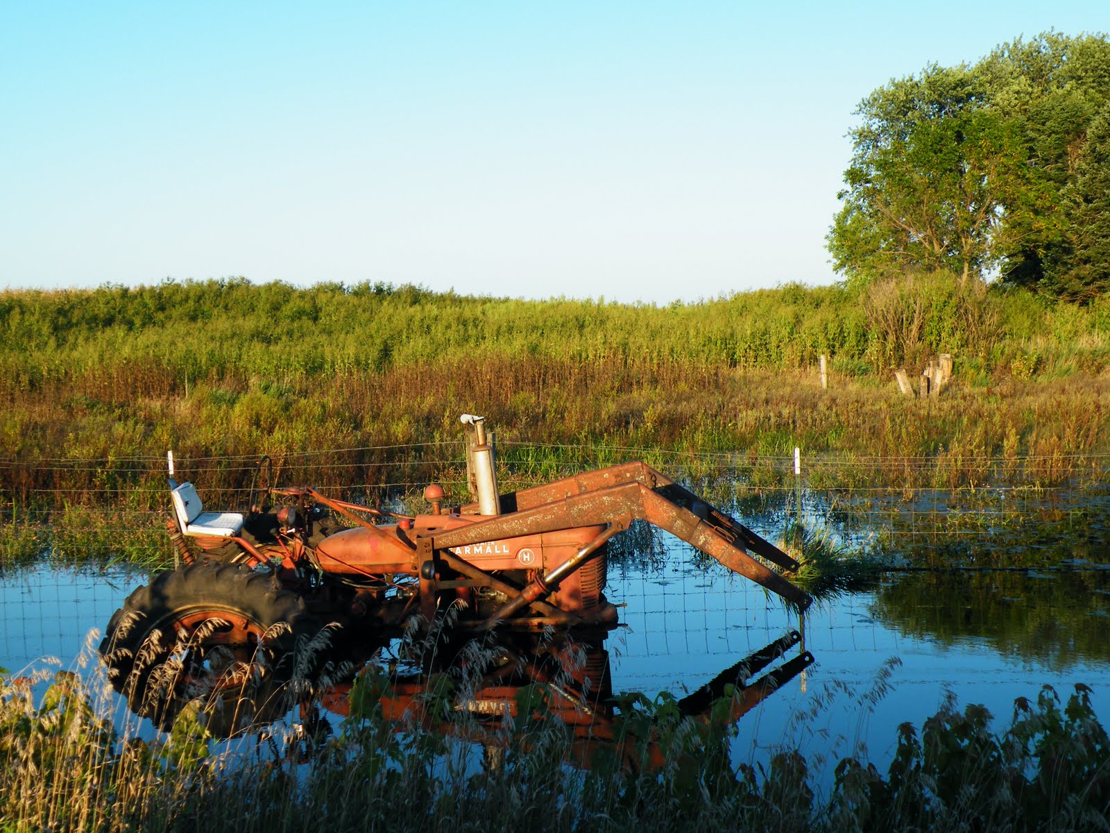 Camp Stanhope Pickles Restaurant in Kamrar and a tractor in water...