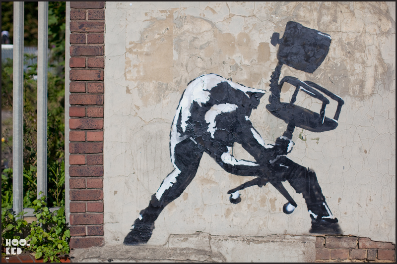 Hoodie Stencil Walking dog stencil by street artist Banksy in South London.