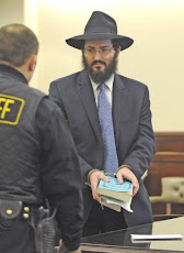 Rabbi Yaakov Weiss holds his prayer books Monday after being sentenced to 60 days in Jail.