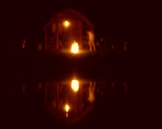 cabin and campfire reflected in pond KOA Canandaigua 2008 jcb