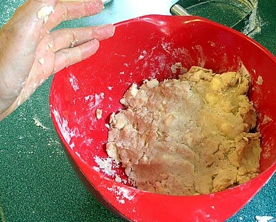the finished dough, with flour crumbs on the bottom of the bowl