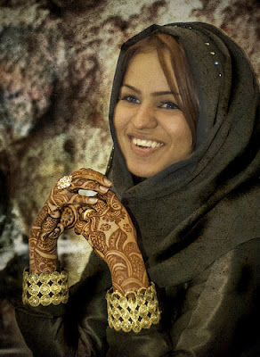 A girl shows off her Henna markings.