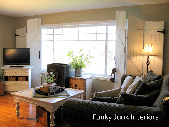Learn how to easily build your own wooden gate window screens on a room divider with plank wood! Perfect for pet households and they resemble gates or barn doors! Click to full tutorial.