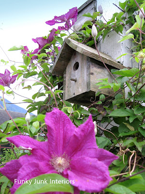 wooden bird house on a pole with clematis / FunkyJunkInteriors.net