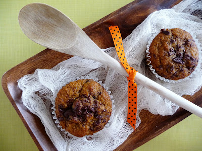 Overhead view of two chocolate chip pumpkin applesauce muffins. 