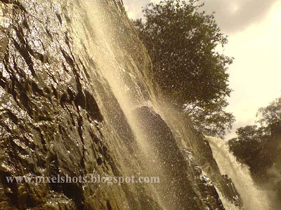 close photograph of the hogenekkal water falls while journey in basket boat