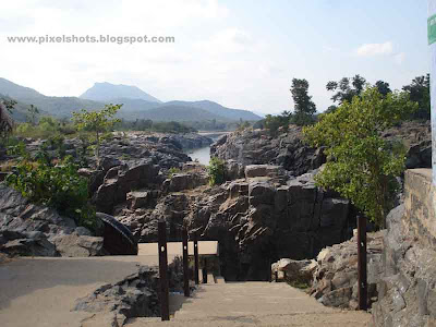landscape of rocks and rivers and steps going down to the basket boat journey starting point in hogenekkal,polished river side rocks,steps to river bank,south indian tour trips,hogenekkal