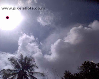 direct photograph of sun and clouds in noon time using mobile phone camera