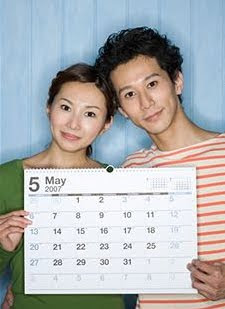 Engaged couple holding calendar