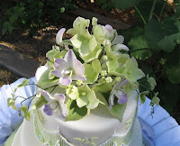 Sugar orchids, hydrangeas, and ivy wedding cake topper