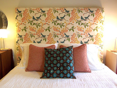 bed with turquoise and orange accent pillows