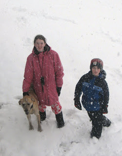 Kids in snow with dog