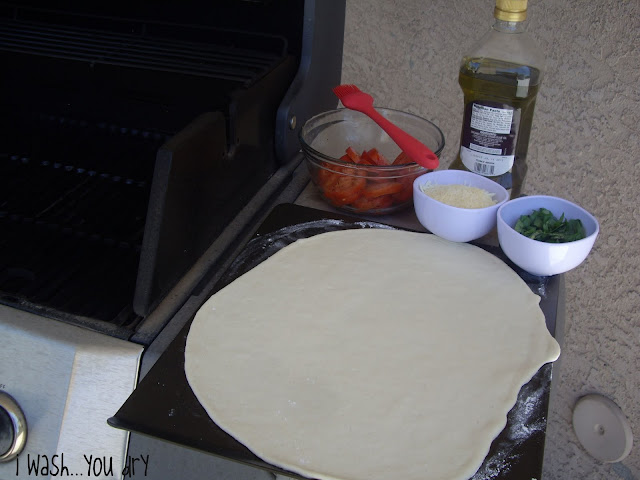 Pizza dough rolled out on a pan. 