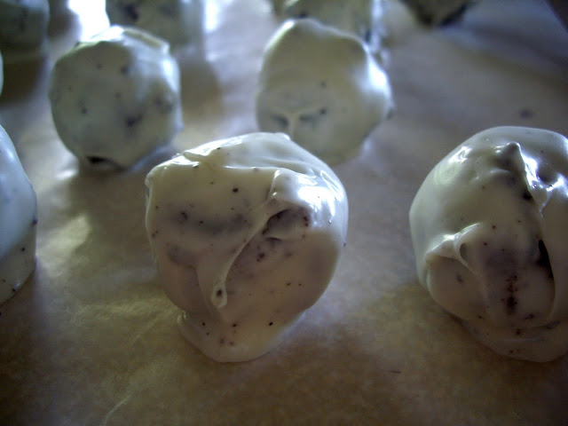 White chocolate dipped Oreo balls on a pan.