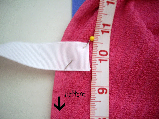 A ribbon pinned onto a dish towel. 