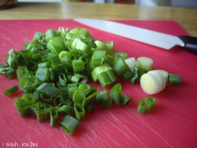 Chopped green onions on a cutting board.