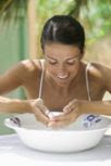woman soaking fingertips