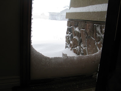 Snow drifted up against the front door.