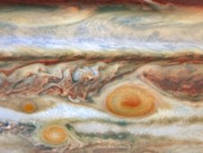 Jupiter's swirling Great Red Spot surrounded by turbulent swirls and eddies.