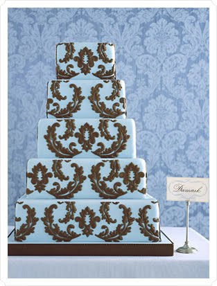 Elegant five tier square wedding cake with light blue icing base and dark 