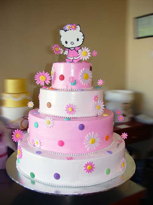 Dainty Hello Kitty wedding cake with Hello Kitty bride and groom on top of a 