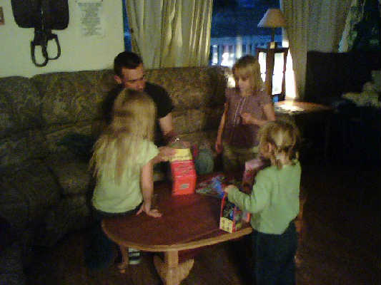 David helping the girls get the presants out of the boxes
