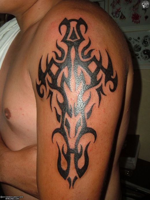 tribal cross arm tattoos