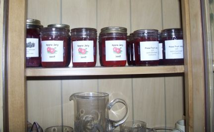 Mixed fruit jelly made from fruit scraps Pantry shelf full of homemade jellies and jams.